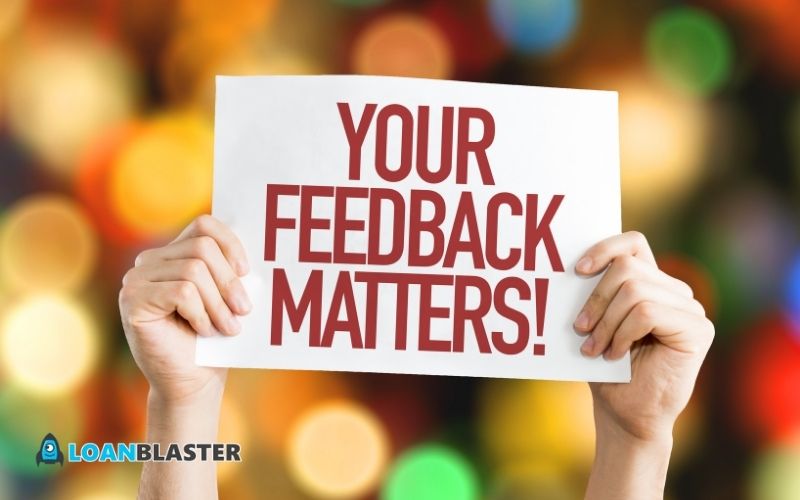 person holding a sign "your feedback matters"